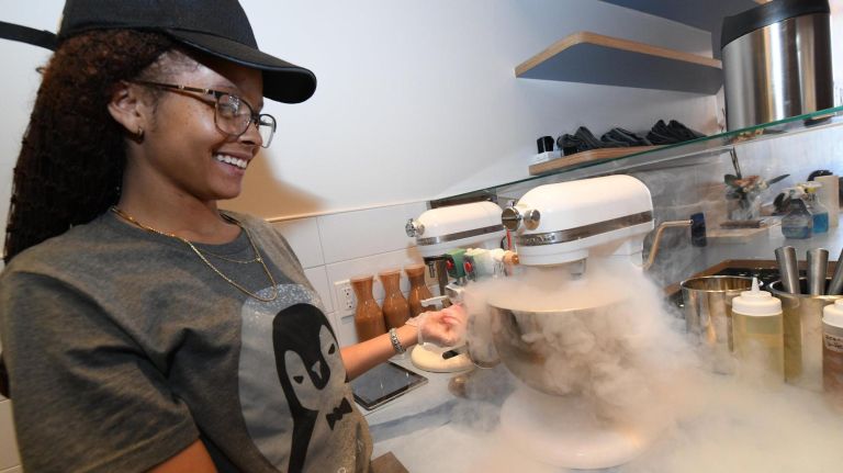An employee at Four Winters Ice Cream adds nitrogen gas to the liquid mixture.