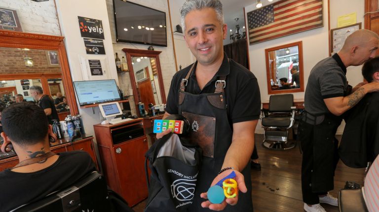 Arthur Iskhakov, owner of Barber's Blueprint in lower Manhattan, received special training to offer autistic children sensory-inclusive haircuts.