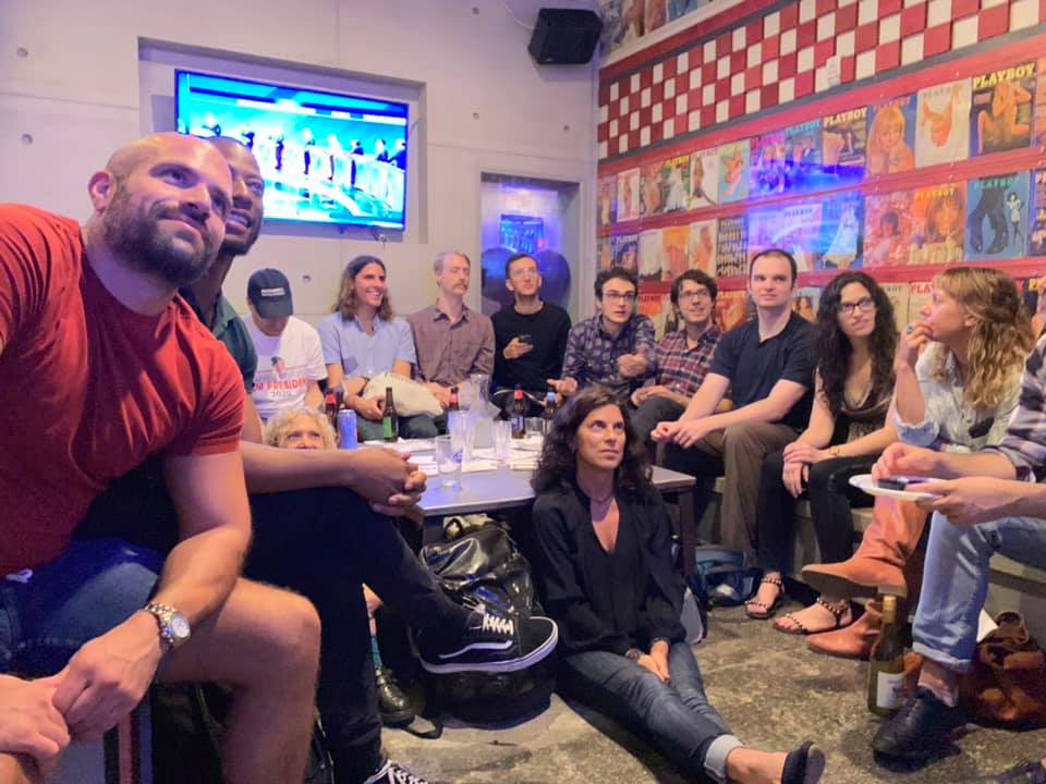 New Yorkers gather in front of the TV screen