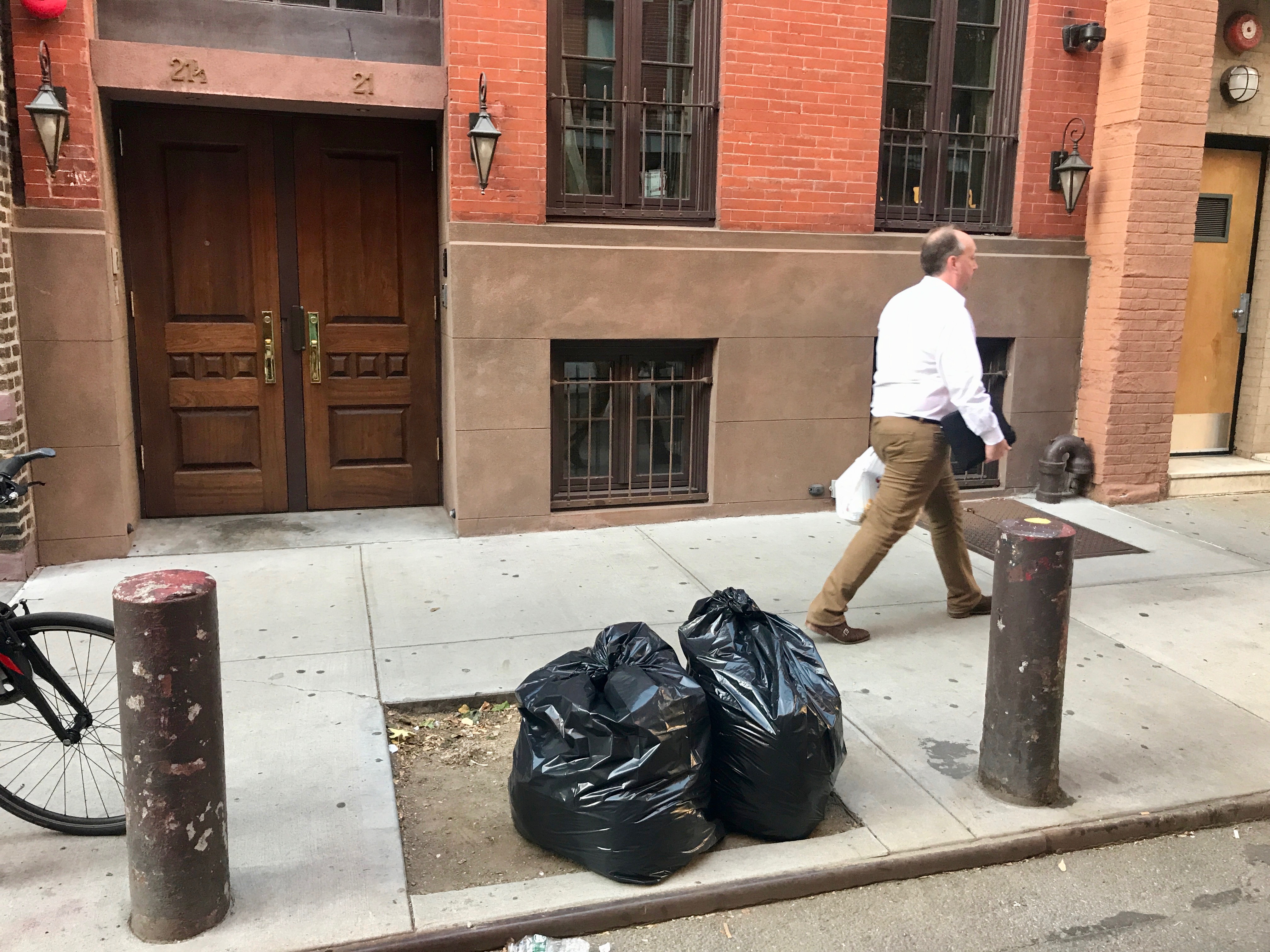 On a recent afternoon the treet pit at 21 Cornelia St was filled with garbage bags Photo by Gabe Herman