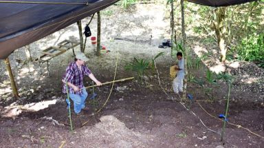 Professor Sheldon Skaggs, left, take measurements in preparation for excavations in Belize for a Bronx Community College Geospatial Center archaeological project he supervises.