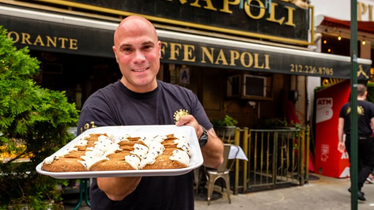 Louis Fontana, of Caffe Napoli, displays cannolis during a preview of preparations for the Feast of San Gennaro.