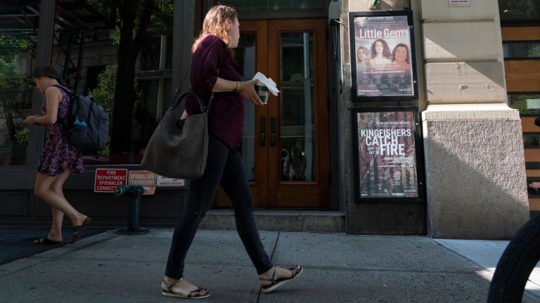 People walk past the Irish Repertory Theatre on West 22nd Street in Manhattan.&nbsp;