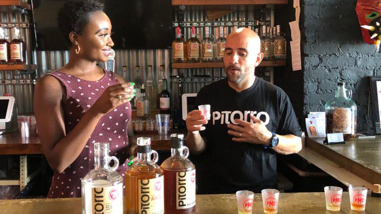 Port Morris Distillery's "OG3," as Rafael Barbosa, right, tells Noëlle Lilley on Sept. 13 are, from left, the Shine, Añejo and Coquito.