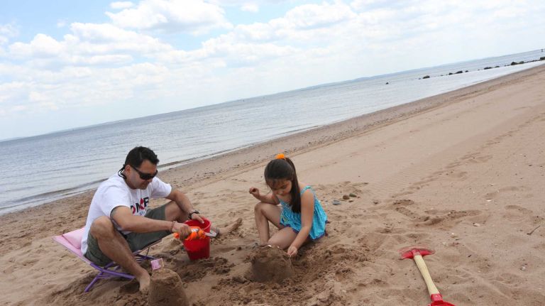 Gulmar Parga, and daughter, Julia, 5, play on the beach in Wolfe's Pond Park in Prince's Bay, Staten Island, Friday, May 22, 2015.