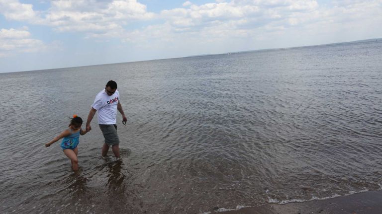 Gulmar Parga, and daughter, Julia, 5, walk in the water in Wolfe's Pond Park in Prince's Bay, Staten Island, Friday, May