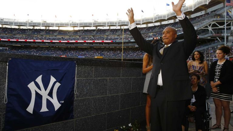 Former New York Yankees centerfielder Bernie Williams waves to fans from Monument Park during a ceremony to retire his No. 51 before a game between the Yankees and the Texas Rangers at Yankee Stadium on Sunday, May 24, 2015.