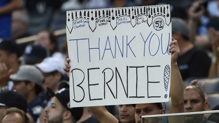 Fans hold a sign during a ceremony to honor former New York Yankees centerfielder Bernie Williams before a game between the Yankees and the Texas Rangers at Yankee Stadium on Sunday, May 24, 2015.