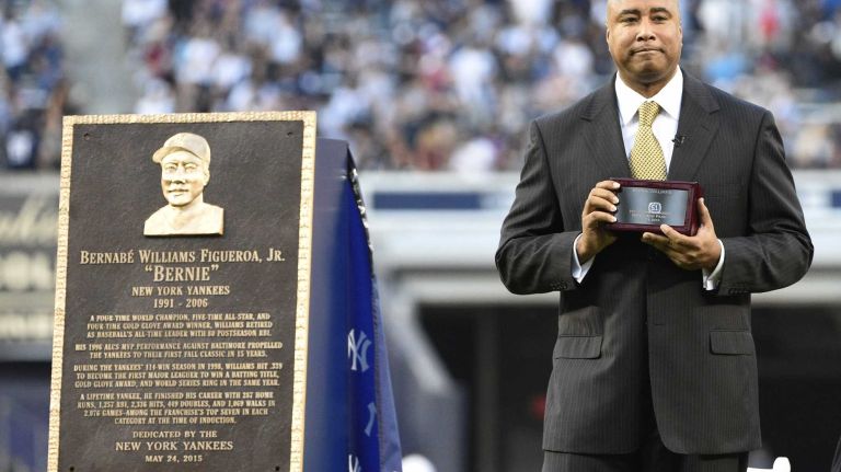 Former New York Yankees centerfielder Bernie Williams stands next to a plaque presented to him during a ceremony to retire his No. 51 before a game at Yankee Stadium between the Yankees and the Texas Rangers on Sunday, May 24, 2015.