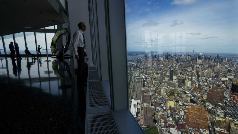 People and views from level 100 of the One World Observatory at One World Trade Center come together Wed., May 20, 2015. The observatory opens officially May 29.