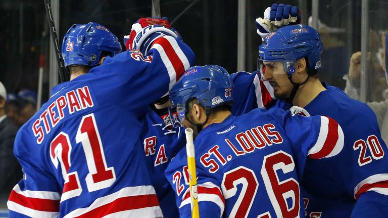 Chris Kreider #20 of the New York Rangers celebrates with his teammates after scoring a first-period power-play goal against the Tampa Bay Lightning during Game 2 of the Eastern Conference finals at Madison Square Garden on Monday, May 18, 2015.