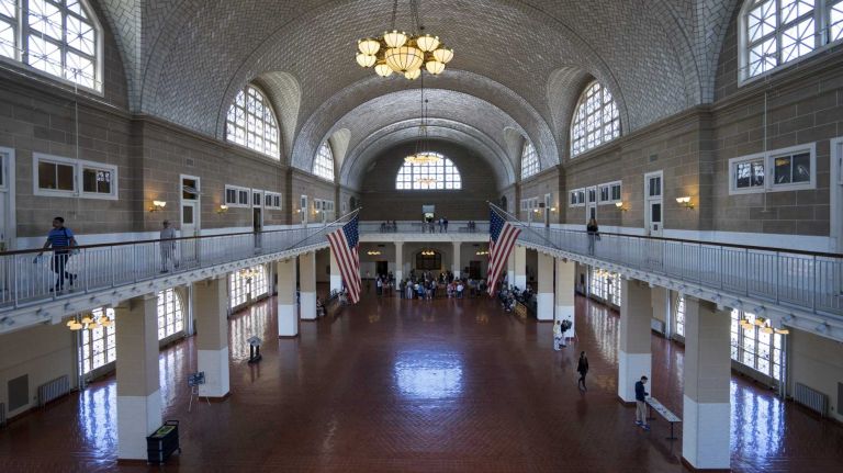 Visitors walk in The Registry Room Ellis Island on May 7, 2015. 