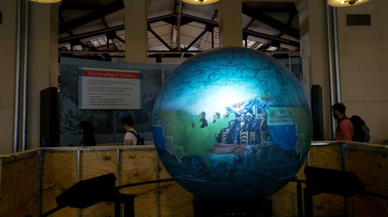 A globe that displays images of global migration of the past and present is previewed May 7, 2015, on Ellis Island, part of The Peopling of America Center that will open May 20th. The new installation will feature exhibitions that chronicle immigration to America before the processing station at Ellis Island opened in 1892 and after it closed in 1954, making it the nation�s official museum chronicling all immigration from the colonial era to today.
