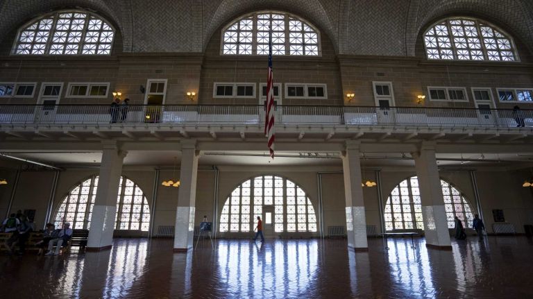 A visitors walks in The Registry Room Ellis Island on May 7, 2015. 