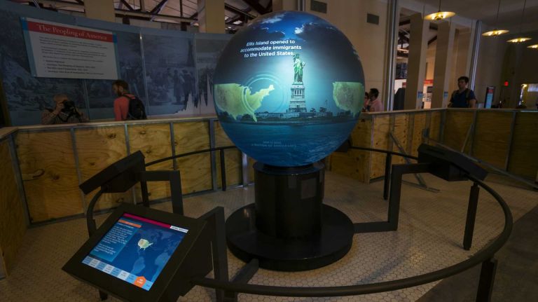 A globe that displays images of global migration of the past and present is previewed May 7, 2015, on Ellis Island, part of The Peopling of America Center that will open May 20.