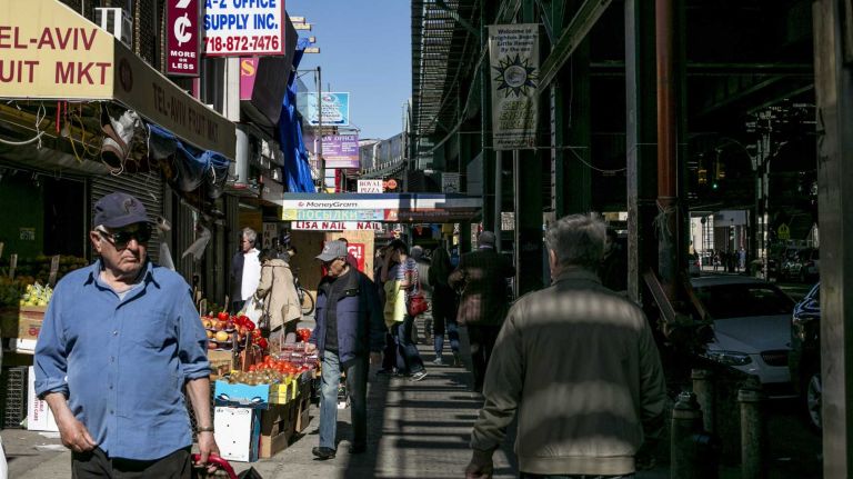 People walk along Brighton Beach Avenue in Brighton Beach in Brooklyn on April 28, 2015. By Anthony Lanzilote
