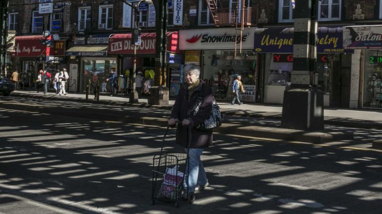 A woman crosses Brighton Beach Avenue in Brighton Beach in Brooklyn on April 28, 2015. By Anthony Lanzilote