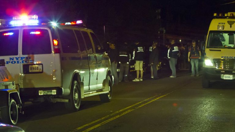 NYPD officers gather in a show of support near the location on 212th Street in Queens Village where a fellow officer was wounded after being shot by a man that police say he and his partner wanted to question.