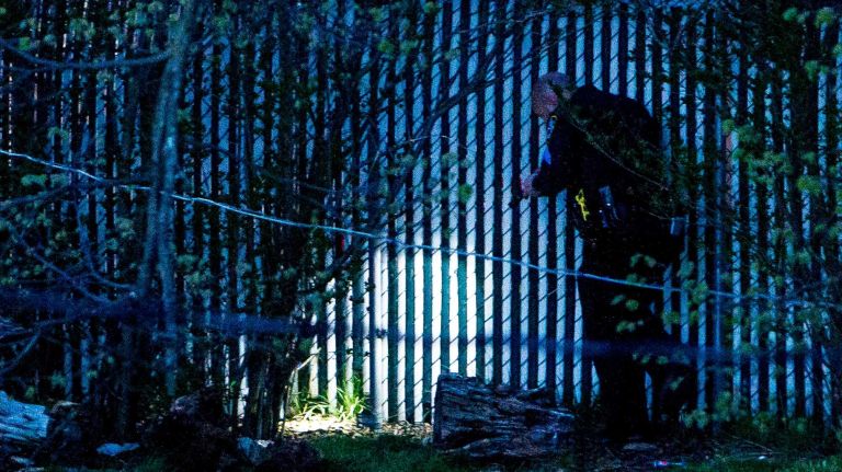 Police investigate the area where an NYPD officer was shot on 104th Road in Queens Village on Saturday, May 2, 2015.
