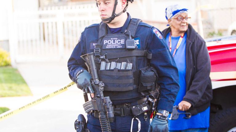 Police search the neighborhood on Saturday, May 2, 2015. The shooting comes five months after two NYPD officers were shot and killed in Brooklyn.