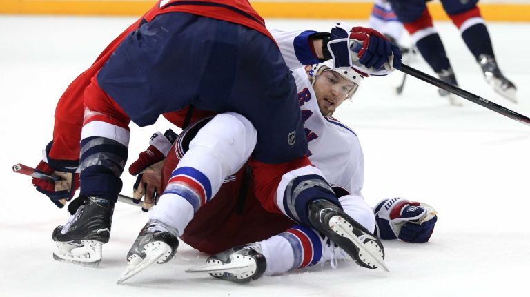Rick Nash #61 of the New York Rangers is body checked by Brooks Orpik #44 of the Washington Capitals during the second period in Game 3 of the Eastern Conference semifinals during the 2015 NHL Stanley Cup playoffs at Verizon Center on May 4, 2015 in Washington.