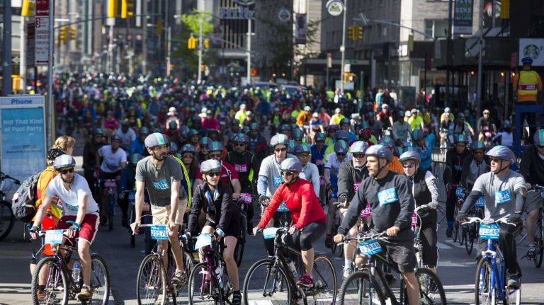 Participants travel north on 6th Ave in Manhattan at Central Park South as they take part in the Five Boro Bike Tour Sunday, May 3, 2015.
