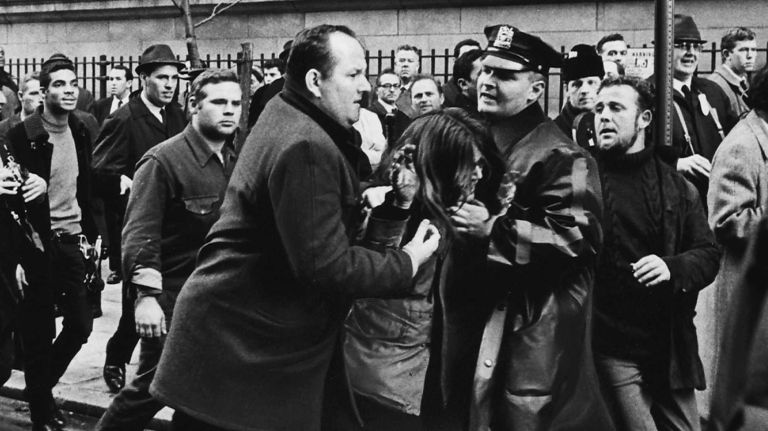 Police haul away a marcher from in front of a U.S. government building opposite Washington Irving High School, after a fight developed when police halted the peace march and would not let the crowd go uptown. (Dec. 8, 1967)
