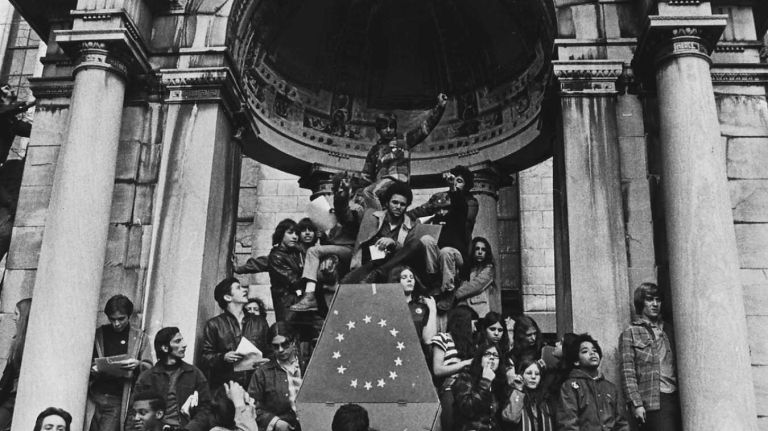 Demonstrators at the Moratorium Rally at Bryant Park are seen listening from various points, some climbing to top of the arch over statue of William Cullen Bryant. (Oct. 15, 1969)