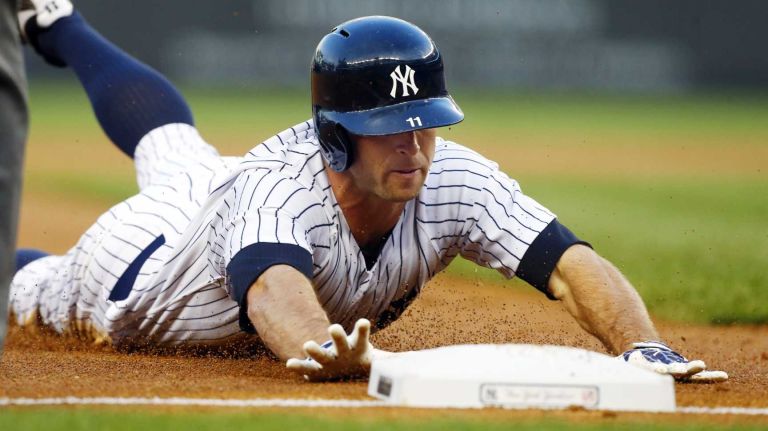 Brett Gardner of the Yankees dives safely into third base after hitting a first inning triple against the Toronto Blue Jays at Yankee Stadium. (May 17, 2013)