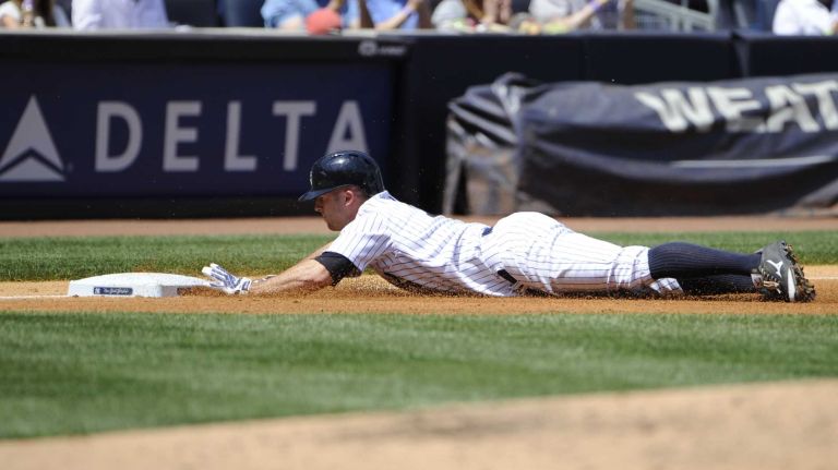 Brett Gardner slides in to third base on his triple against the Minnesota Twins on June 1, 2014.