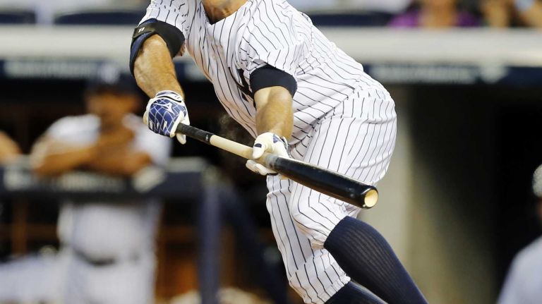 Brett Gardner of the Yankees connects on a first-inning bunt single against the Boston Red Sox at Yankee Stadium on Wednesday, Sept. 3, 2014.