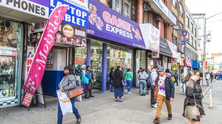 Pedestrians walk by Game Express in the Melrose neighborhood in the Bronx on April 15, 2015. 