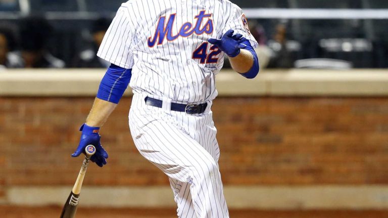 Lucas Duda #21 of the New York Mets follows through on a fifth inning home run against the Philadelphia Phillies at Citi Field on Wednesday, Apr. 15, 2015 in the Queens Borough of New York City. Players, managers and coaches are all wearing #42 in honor of Jackie Robinson Day.