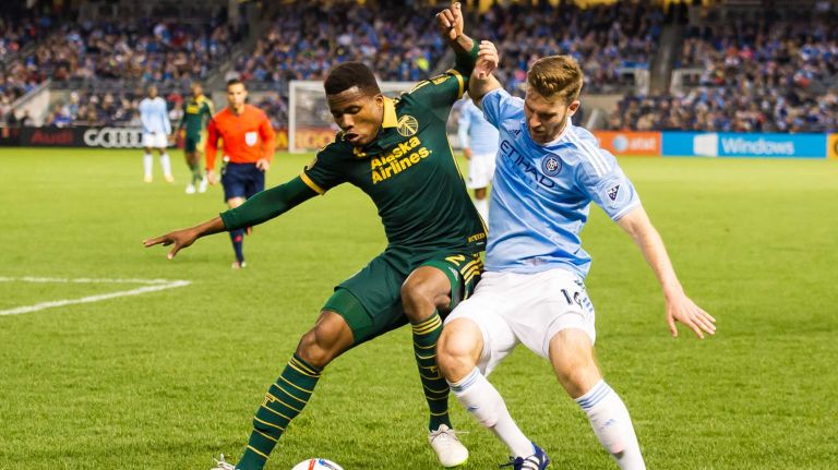 New York City FC forward Patrick Mullins (14) and Portland Timbers defender Alvas Powell (2) battle for the ball in a game at Yankee Stadium on Sunday, April 19, 2015.