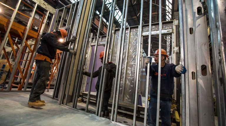 Carpenters installing an already framed wall to one of the modules by Capsys Corp., a modular manufacturer, at the Brooklyn Navy Yard, April 9, 2015, part of New York City's micro apartment project. Once completed, the apartments will be moved to Manhattan later date. April 9, 2015.