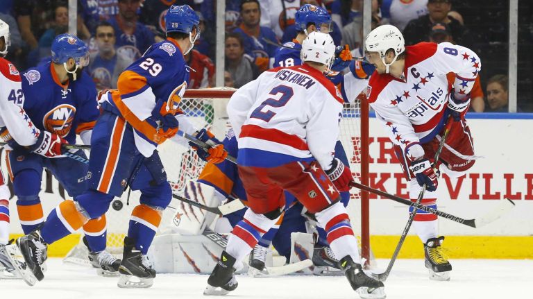 Alex Ovechkin #8 and Matt Niskanen #2 of the Washington Capitals watch the puck enter the net for a third-period goal against the New York Islanders scored by teammate Nicklas Backstrom (not pictured) during Game 3 of the Eastern Conference quarterfinals at Nassau Coliseum on Sunday, April 19, 2015.