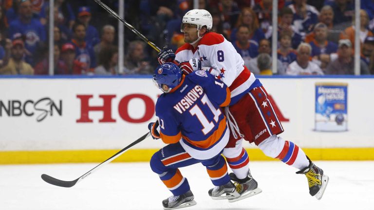 Alex Ovechkin #8 of the Washington Capitals checks Lubomir Visnovsky #11 of the New York Islanders in the second period during Game 3 of the Eastern Conference quarterfinals at Nassau Coliseum on Sunday, April 19, 2015.