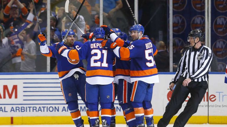 Kyle Okposo #21 of the New York Islanders celebrates his second period goal against the Washington Capitals with his teammates during game three of the Eastern Conference Quarterfinals at Nassau Coliseum on Sunday, Apr. 19, 2015 in Uniondale, New York.