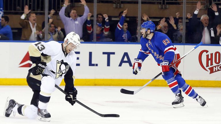 Keith Yandle of the New York Rangers celebrates a first-period goal scored by teammate Ryan McDonagh (not pictured) as Nick Spaling of the Pittsburgh Penguins looks on during Game 1 of the Eastern Conference Quarterfinals at Madison Square Garden on Thursday, April 16, 2015.
