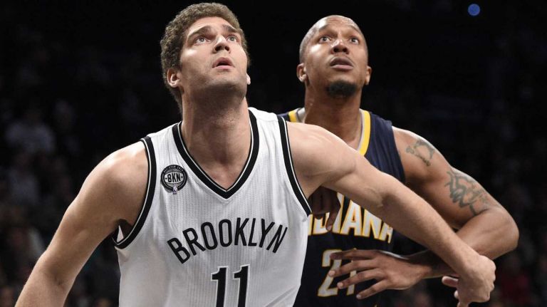 Brooklyn Nets center Brook Lopez and Indiana Pacers forward David West look to rebound in the first half of an NBA game at Barclays Center on Saturday, Dec. 27, 2014.