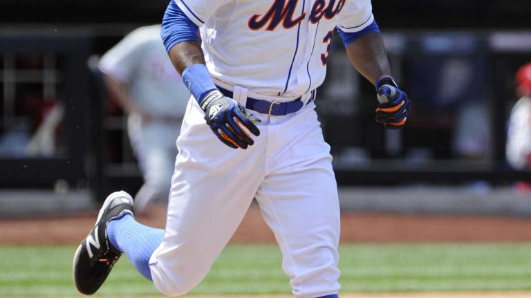 New York Mets Curtis Granderson runs to first after drawing a walk against the Philadelphia Phillies in the fifth inning of an MLB baseball game at Citi Field on Wednesday, July 30, 2014.
