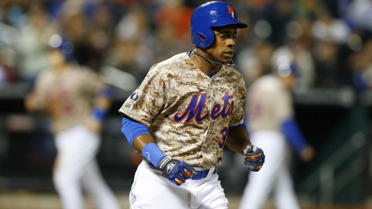 Curtis Granderson of the Mets draws a seventh-inning bases loaded walk against the Miami Marlins, scoring teammate Travis d'Arnaud #15 at Citi Field on Monday, Sept. 15, 2014.