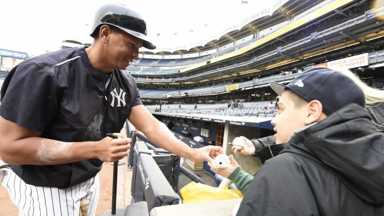 The New York Yankees' Alex Rodriguez signs autographs for fans after batting practice at Yankee Stadium before a game against the Toronto Blue Jays on Wednesday, April 8, 2015.