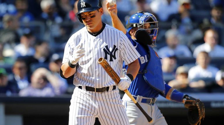 Jacoby Ellsbury #22 of the New York Yankees walks back to the dugout after striking out in the eighth inning against the Toronto Blue Jays during Opening Day at Yankee Stadium on Monday, April 6, 2015.
