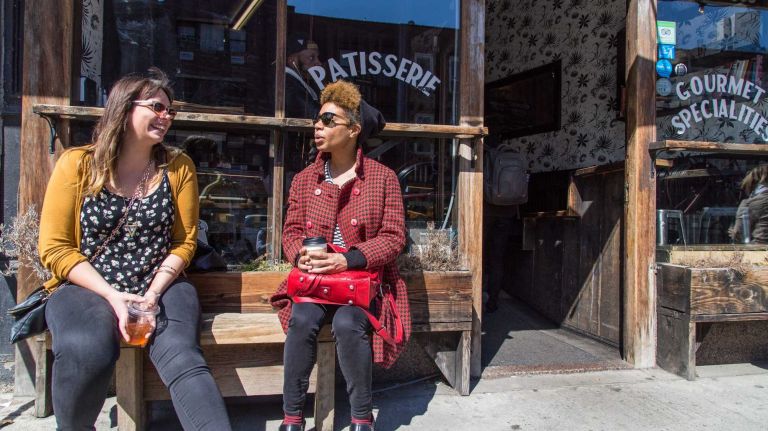 Stephanie Anderson, left, of Clinton Hill and Daonne Huff of Prospect Heights sit in front of Benny's bakery in the Clinton Hill neighborhood of Brooklyn on April 6, 2015. Neighborhood Feature on Clinton HIll.