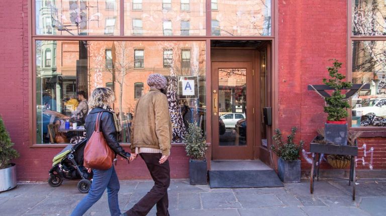 Customers enter Urban Vintage in the Clinton Hill neighborhood of Brooklyn on April 6, 2015. Neighborhood Feature on Clinton HIll.