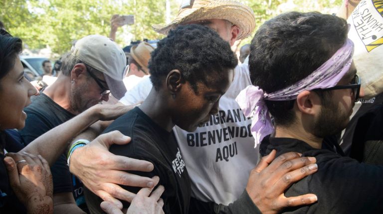 Therese Patricia Okoumou, center, is surrounded by supporters and fellow activists as she exits a federal courthouse in Manhattan after being arraigned Thursday. Okoumou ascended the statue in protest of the Trump administration's immigration policies.