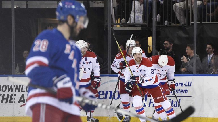 Rangers vs. Capitals 26 The Washington Capitals celebrate a goal by left wing Jason Chimera as New York Rangers center Dominic Moore skates by in the third period of a game at Madison Square Garden on Sunday, March 29, 2015.