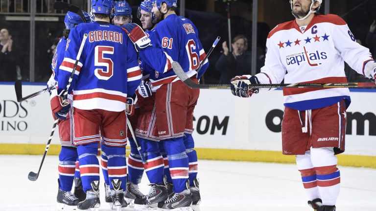 Rangers vs. Capitals 43 The New York Rangers celebrate a goal by New York Rangers center Derick Brassard as Washington Capitals left wing Alex Ovechkin skates by in the first period of an NHL hockey game at Madison Square Garden on Sunday, March 29, 2015.