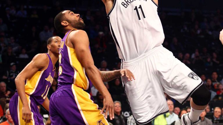 Brooklyn Nets center Brook Lopez #11 shoots against Los Angeles Lakers shooting guard Wayne Ellington #2 during the first quarter of a game at Barclays Center on Sunday, March 29, 2015.